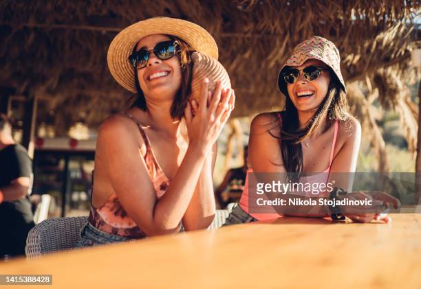 girls having fun cheering with cocktails at bar on the beach - ibiza party stock pictures, royalty-free photos & images