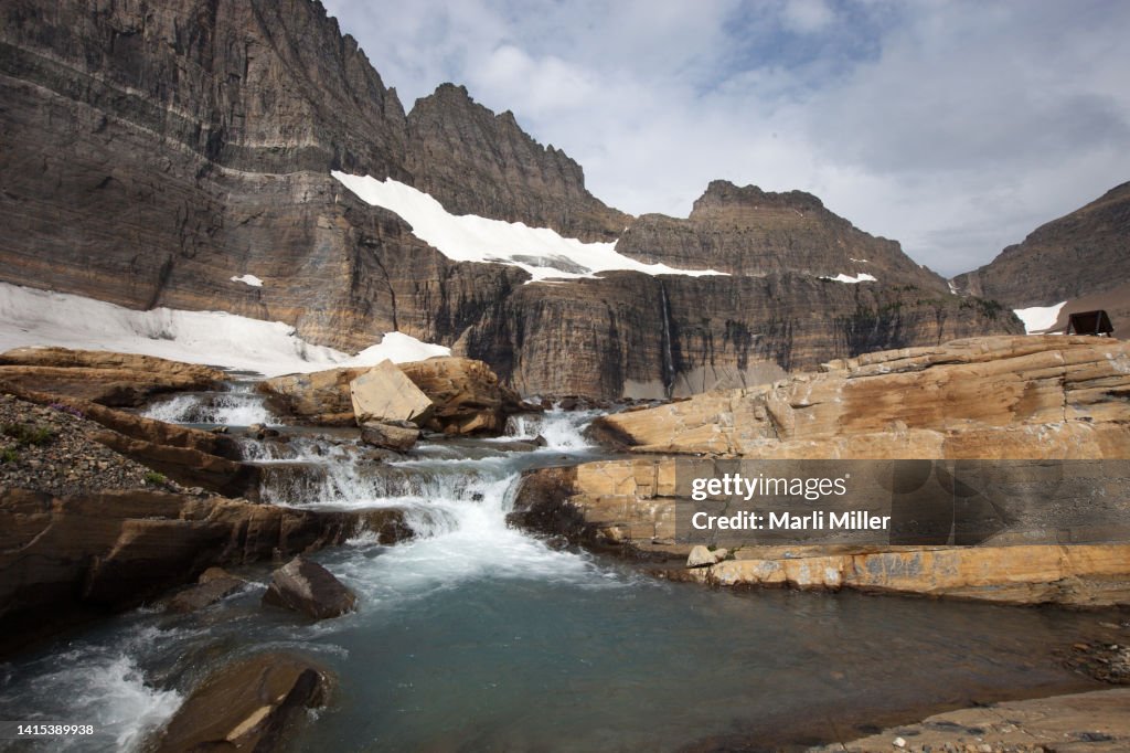 Stream flowing over ledges in glacier cirque, Glacier National Park, Montana, USA