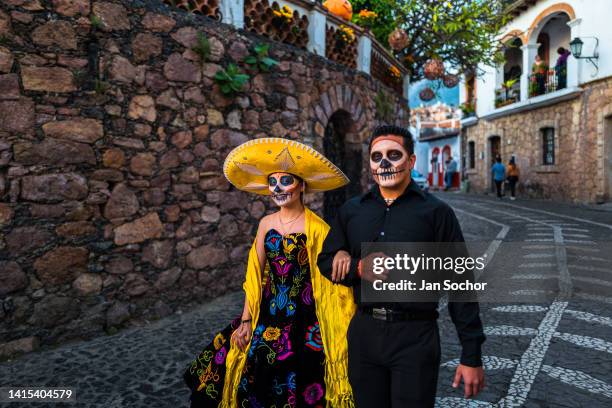 Young Mexican couple, dressed as La Catrina and Catrin, takes part in the Day of the Dead celebrations on October 30, 2021 in Taxco de Alarcón,...