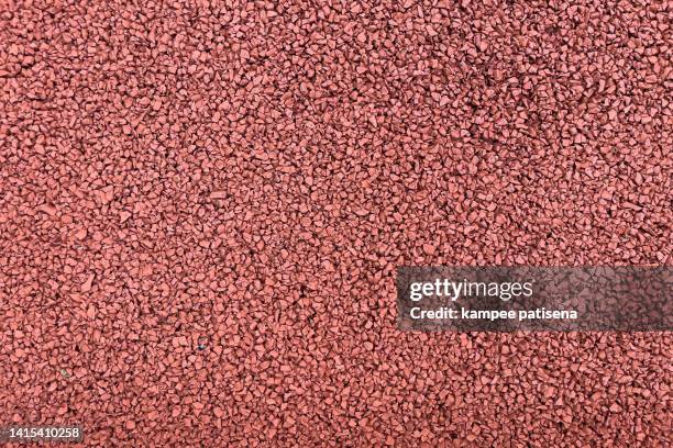 texture of red asphalt. rubber material used in playgrounds. - pellet stock pictures, royalty-free photos & images