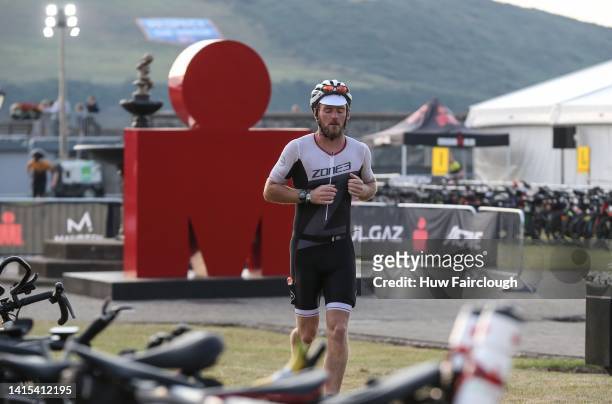 An athelete runs through transition to collect his bike during IRONMAN Ireland, Cork on August 14, 2022 in Cork, Ireland.