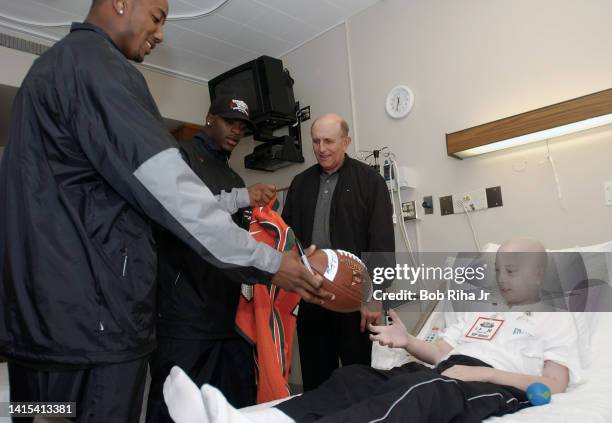 Miami Hurricanes players Mike Rumph , Clinton Portis and Head Coach Larry Coker visit with Pediatric cancer patient during visit to the City of Hope,...