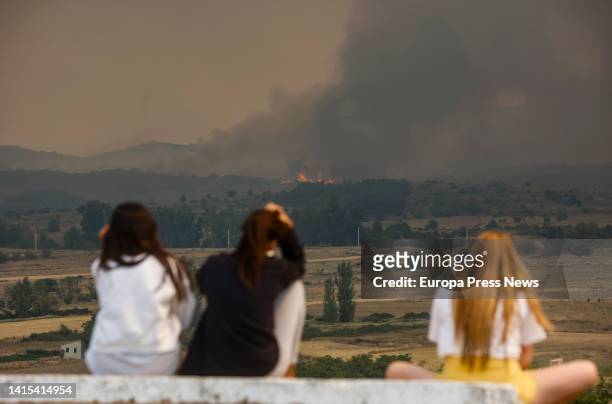 Several people watch the flames and smoke of the Bejis fire from the municipality of El Toro, on 17 August, 2022 in Castellon, Valencian Community,...