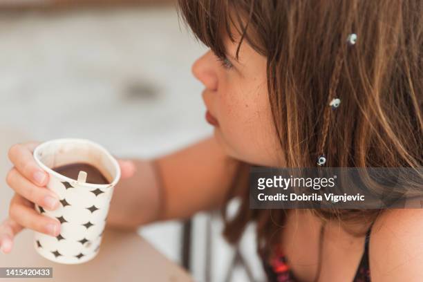 close-up of a teenage girl holding a cup of hot chocolate - tween girls hot imagens e fotografias de stock
