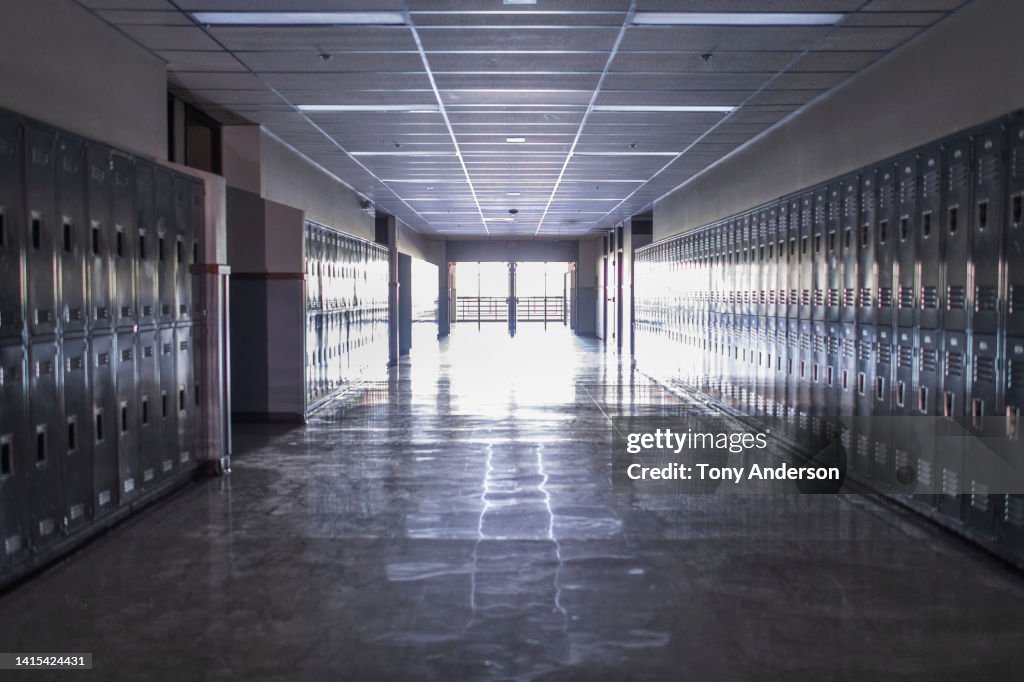 Empty high school corridor with lockers lining the walls
