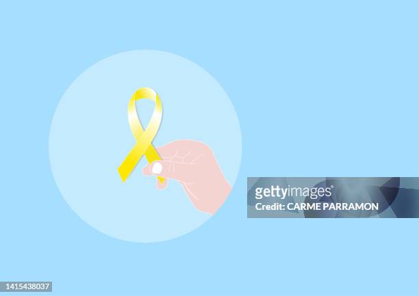 a little boy's hand holding a golden childhood cancer ribbon - childhood cancer stock illustrations