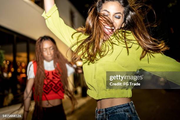 female friends having fun at city by night - girls dancing stock pictures, royalty-free photos & images