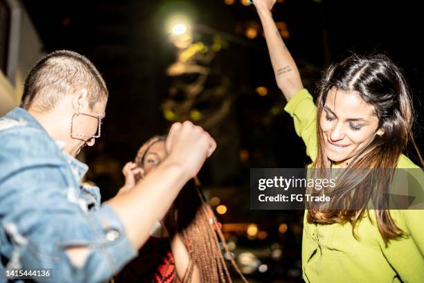 female friends having fun at city by night - girls' night in stock pictures, royalty-free photos & images