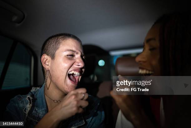 friends singing in the car - girl singing stock pictures, royalty-free photos & images