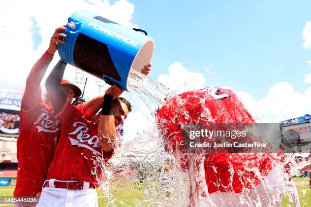 Jose Barrero of the Cincinnati Reds celebrates a walk off single with Albert Almora Jr. #3 and Kyle Farmer after the game against the Philadelphia...