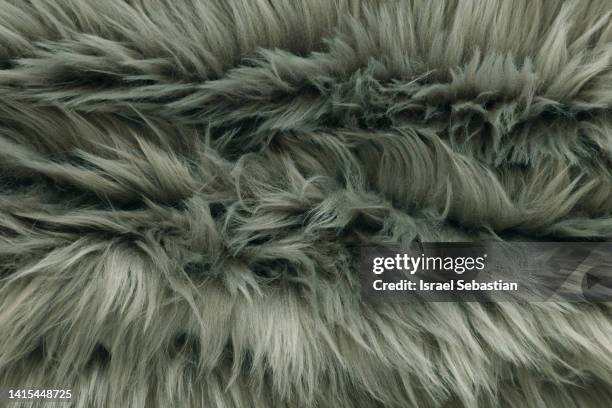 close-up of a fake fur fabric of long brown hair. - fake fur stock pictures, royalty-free photos & images