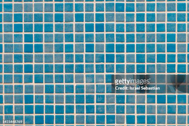 square tile background at the bottom of a swimming pool. - blue tiles stock pictures, royalty-free photos & images