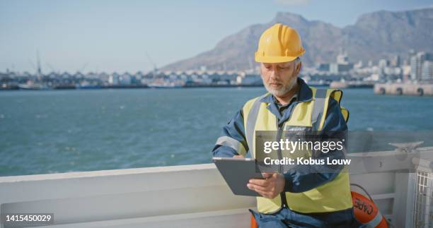 logistics worker, manager and employee on tablet, shipping products and transporting cargo on a boat on sea in summer. boss browsing the internet and checking arrival time for shipment online - marine engineering stock pictures, royalty-free photos & images