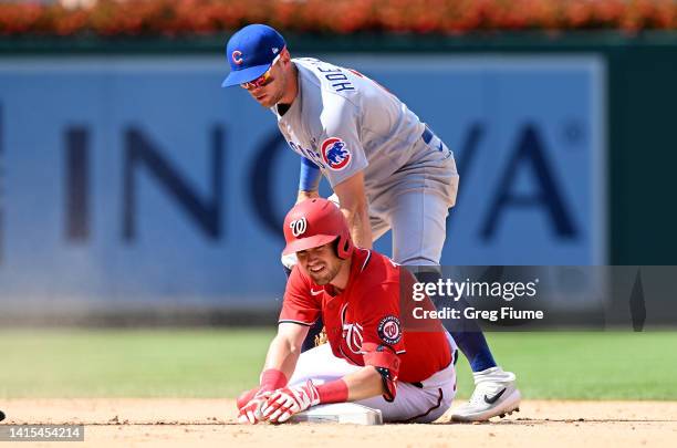 Lane Thomas of the Washington Nationals slides into second base with a double in the eighth inning ahead of the tag of Nico Hoerner of the Chicago...