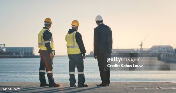 logistics, inspecting and planning group of businessmen, engineer and construction worker site seeing at the port. executive and quality control officer at docks for international shipping business. - marine engineering stock pictures, royalty-free photos & images