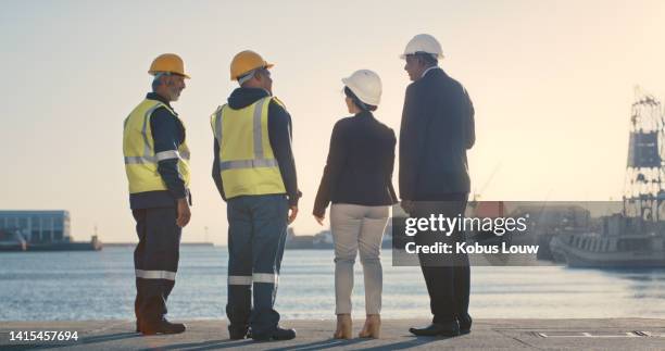 logistics workers meeting with shipping or construction engineers, working at loading dock by sea and talking about shipment at harbor. corporate colleagues doing inspection and planning cargo - marine engineering stock pictures, royalty-free photos & images