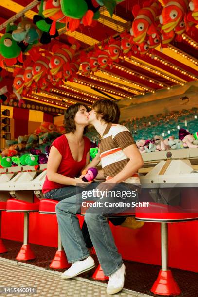 young couple kissing - the ride of champions stock pictures, royalty-free photos & images