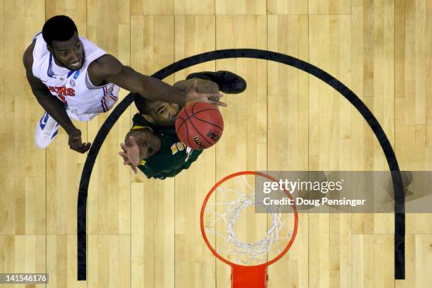 Patric Young of the Florida Gators reaches for a rebound in the first half against Kyle O'Quinn of the Norfolk State Spartans during the third round...