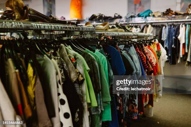 clothing in a vintage second hand shop - clothing racks stock pictures, royalty-free photos & images