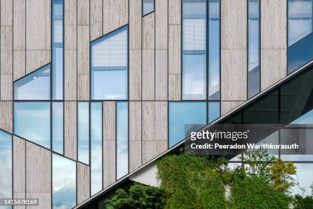 detail of modern green building's facade. - cladding stockfoto's en -beelden