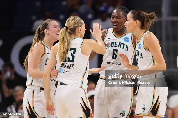 Marine Johannes of the New York Liberty celebrates a three pointer and a foul with teammates against the Chicago Sky during the first half in Game...