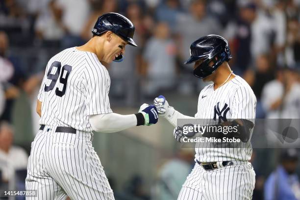 Gleyber Torres of the New York Yankees celebrates with Aaron Judge after hitting a two-run home run to left field in the sixth inning against the...
