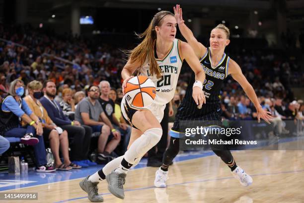 Sabrina Ionescu of the New York Liberty drives to the basket against Courtney Vandersloot of the Chicago Sky during the second half in Game One of...