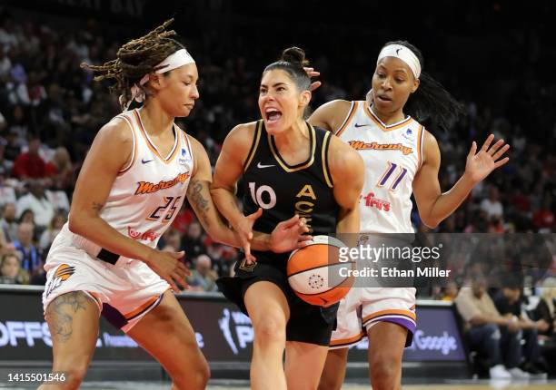 Jennie Simms of the Phoenix Mercury knocks the ball away from Kelsey Plum of the Las Vegas Aces as Shey Peddy of the Mercury defends in the second...