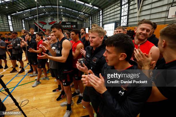 Bombers players react as Michael Hurley of the Bombers speaks to the media during an Essendon Bombers AFL training session at The Hangar on August...