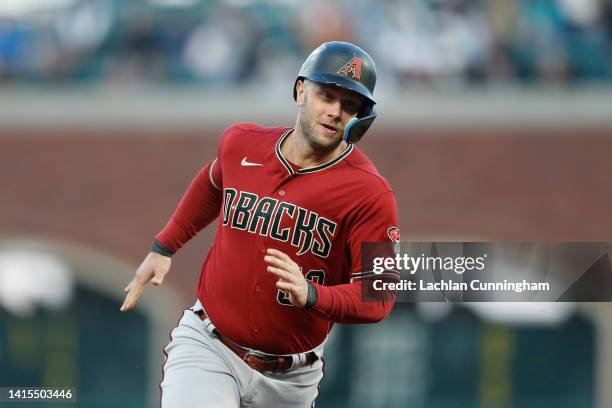 Christian Walker of the Arizona Diamondbacks rounds the bases to score on a double by Stone Garrett in the top of the fourth inning against the San...