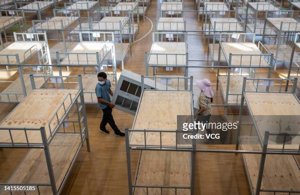 People work at the construction site of a COVID-19 makeshift hospital on August 17, 2022 in Haikou, Hainan Province of China. The 1500-bed makeshift...