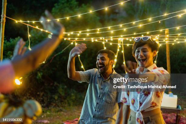 group of young friends arriving at an outdoor party. - 25 29 years stock pictures, royalty-free photos & images
