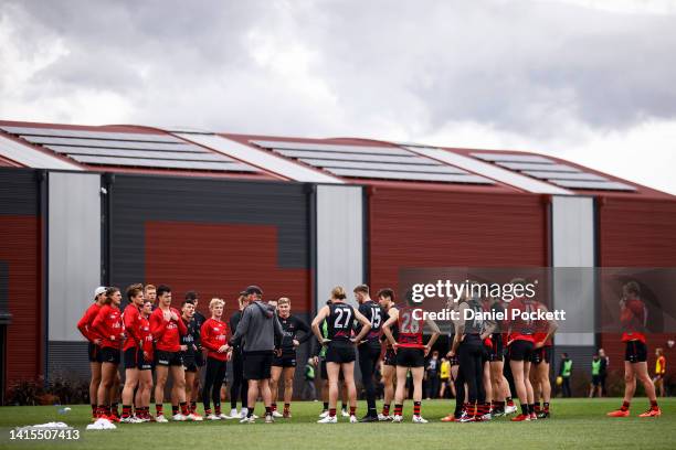 General view as Bombers head coach Ben Rutten instructs his players during an Essendon Bombers AFL training session at The Hangar on August 18, 2022...