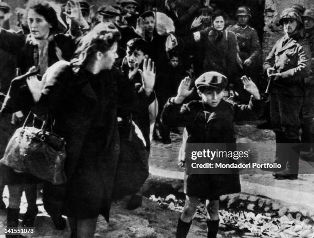 During an SS search in the ghetto, Jews surrendering to the German soldiers, Warsaw Ghetto Uprising, Warsaw, April 1943