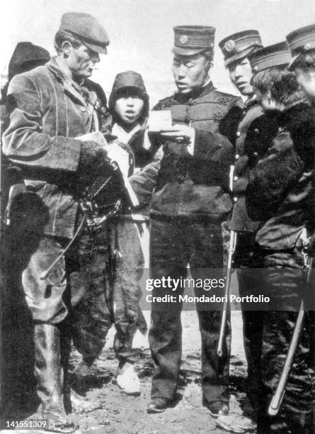 American writer and journalist Jack London showing his pass to some Japanese soldiers. At the time he was special correspondent for the media company...