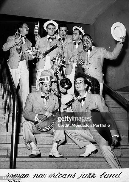 Italian members of the 'Roman New Orleans Jazz Band' posing on the steps of a nightclub. Italy, 1950s