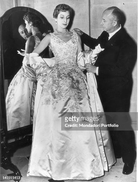 French fashion designer Christian Dior arranging one of his evening ...