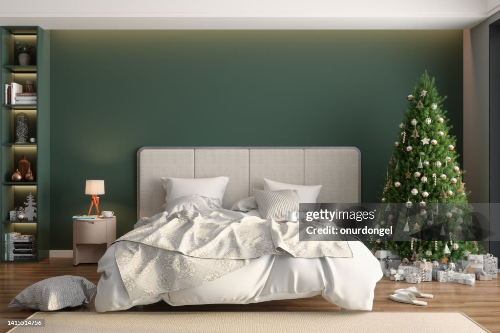 Modern Bedroom Interior With Christmas Tree, Ornaments, Gift Boxes And Messy Bed