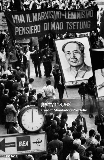 Crowd taking the streets to demonstrate with banners in favour of Sinophile Communism and Mao Zedong. Milan, 1968