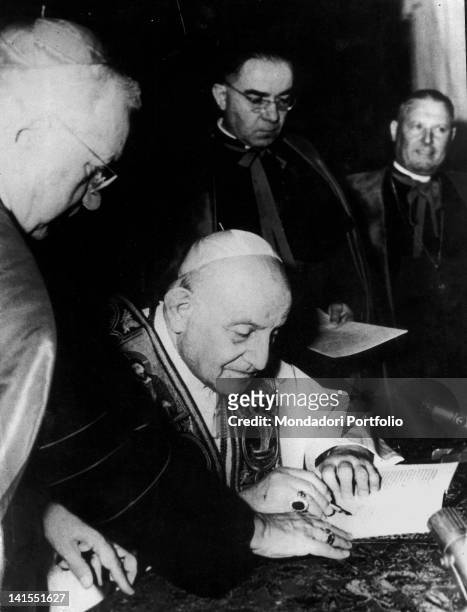 Pope John XXIII sign Encyclical Pacem in Terris at the presence of Vatican Secretary of State Amleto Cicognani. Vatican City, 9th April 1963