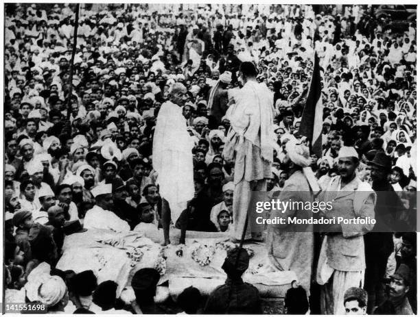 Mahatma Gandhi speaking to the crowd on a makeshift stage druing a rally. Peshawar, July 1938