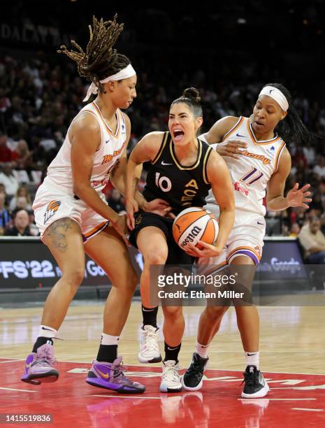 Jennie Simms of the Phoenix Mercury knocks the ball away from Kelsey Plum of the Las Vegas Aces as Shey Peddy of the Mercury defends in the second...