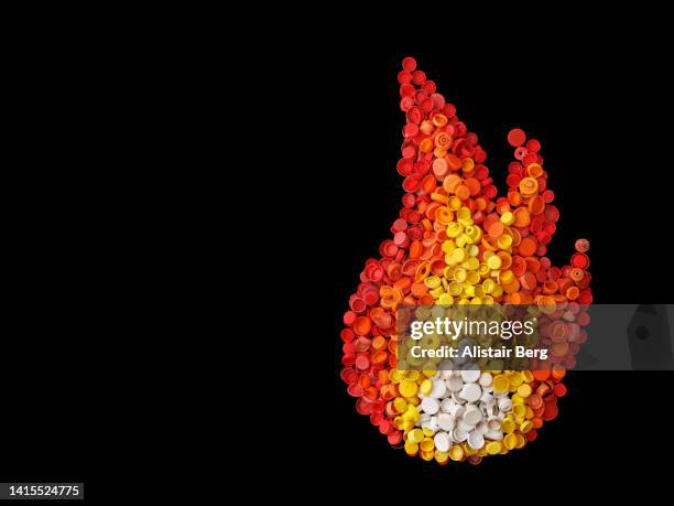 flame created from plastic pollution washed up on the beach - 合成樹脂 ストックフォトと画像