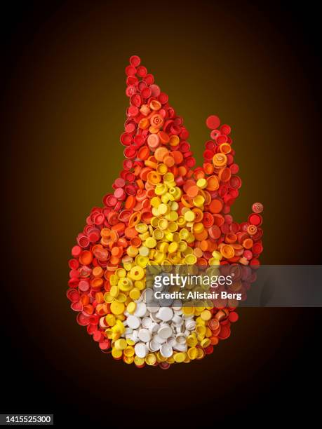 flame created from plastic pollution washed up on the beach - polimero foto e immagini stock