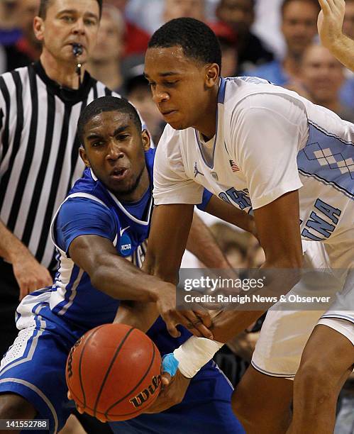 Creighton guard Austin Chatman swats at the ball and hits North Carolina forward John Henson injured wrist in the first half of the NCAA Tournament...