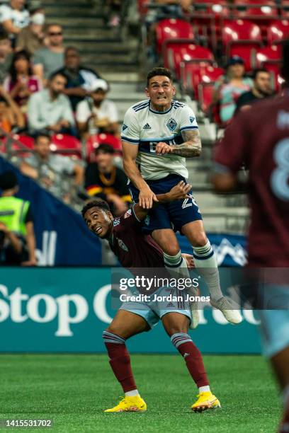 Jake Nerwinski of the Vancouver Whitecaps FC leaps over Jonathan Lewis of the Colorado Rapids in the second half at BC Place on August 17, 2022 in...