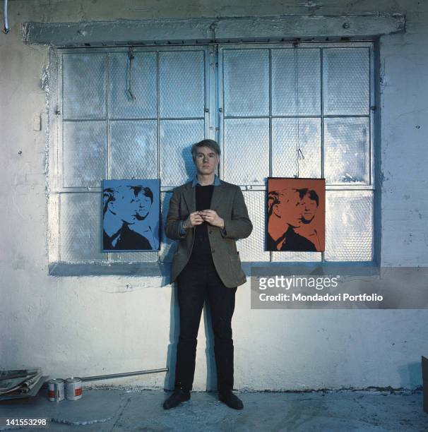 The American artist Andy Warhol posing between two of his works. New York, 1964