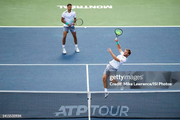 Kevin Krawietz of Germany jumps for a shot with partner Andreas Mies of Germany against Neal Skupski of Great Britain and Wesley Koolhof of The...