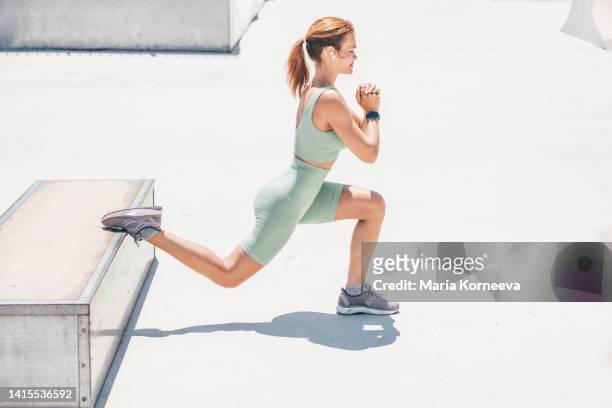 woman doing sport exercise in city park. - cellulite concept stock pictures, royalty-free photos & images