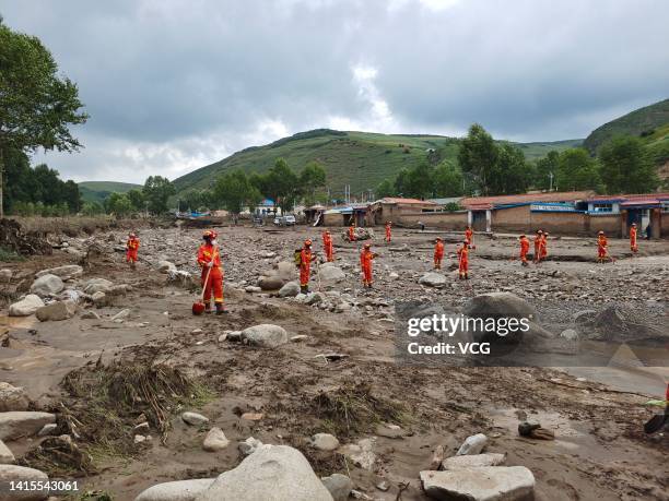 Firefighters search for missing people after a mountain torrent hits Datong Hui and Tu Autonomous County on August 18, 2022 in Xining, Qinghai...